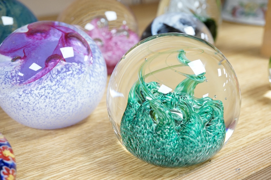 A collection of glass paperweights to include Caithness and millefiori examples, largest 10cm high
